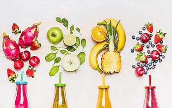Bottles of Fruits smoothies with various ingredients on white wooden background, top view.  Superfoods and healthy lifestyle or detox  diet food concept.
