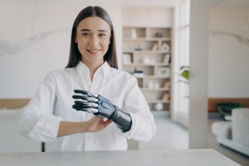 Confident young woman showcasing her bionic arm, embodying the seamless blend of technology and human resilience