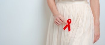 woman with Red Ribbon for December World Aids Day, acquired immune deficiency syndrome, Sexual Transmitted diseases, Syphilis, Chancroid, Genital Herpes, Gonorrhea, Healthcare and world cancer day