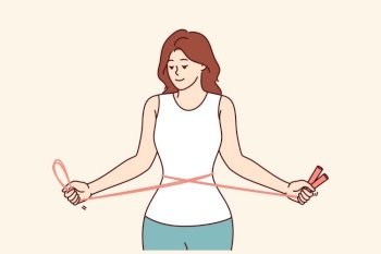 Fitness woman training with jump rope in hands, showing off slender figure and thin waist. Girl fitness trainer in sportswear recommends doing sports to get rid of excess weight and health problems.. Fitness woman training with jump rope in hands, showing off slender figure and thin waist