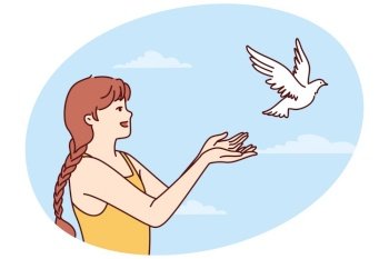 Little girl volunteers teenager sets dove free and lets bird fly towards sky for family reunion. Dove symbolizes peace and prosperity or activism to protect animal birds locked in cages. Little girl volunteers teenager sets dove free and lets bird fly towards sky for family reunion