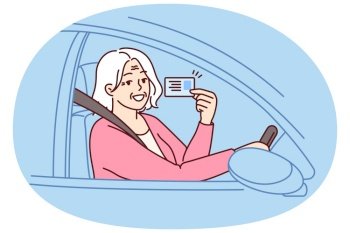 Happy elderly woman demonstrates driver license sitting behind wheel of car and rejoices at opportunity to go on road trip. Positive grey-haired old lady got driver ID after retirement. Happy elderly woman demonstrates driver license for road trip sitting behind wheel of car