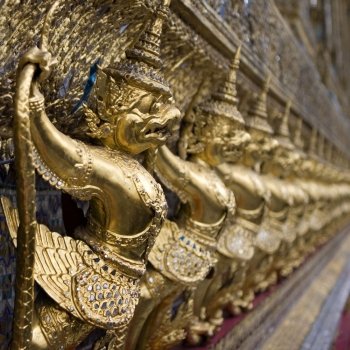 The Grand Palace. Temple of the Emerald Buddha. Gold ornamental patter statuettes. Temple of the Emerald Buddha
