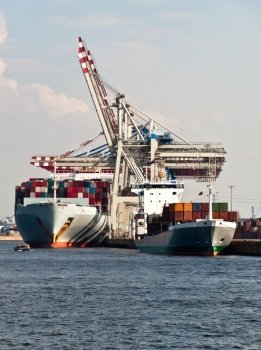 Large container ships being unloaded in Hamburg Dock, Germany. Hamburg is the second biggest container port in Europe and can serve the largest ships.