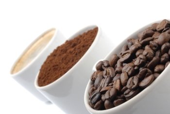 cups with coffe beans, blend and espresso. closeup