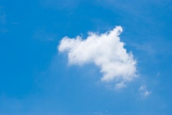 Blue sky with single white cloud, purity natural background.