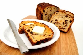 Raisin Cinnamon Toast. Raisin bread toast with melting butter on top ready to be spread