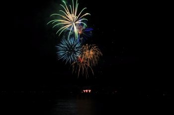 Fireworks In A Rainbow Of Colors. Colorful nighttime fireworks against a solid black sky over Lake Tahoe on the fourth of July holiday 2010