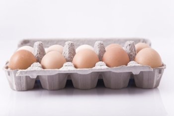 eggs in carton with white background