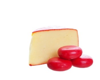Red waxed goumet cheeses on a white background.