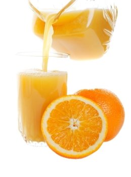 Sweet, refreshing orange juice being poured into a glass.  Studio isolated on white background.