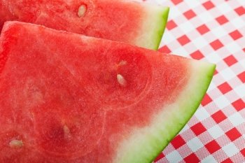 Closeup of two slices of juicy. red watermelon.  Shallow depth of field.