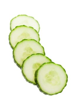 Five slices of English cucumber, cut and ready for a salad or garnish.  Shot on white background.