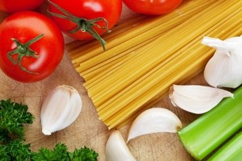 Pasta along with fresh vegetables to make sauce with.