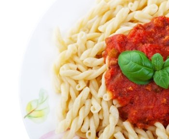 Gemelli Pasta with tomato sauce and fresh basil.  Shot on white background.