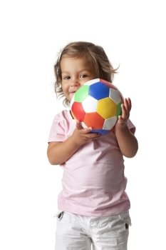  Toddler girl playing with a colored ball on white background