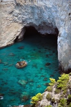 Panoramic view of rocky blue water beach and cave in Keri, Zakynthos, Greece.