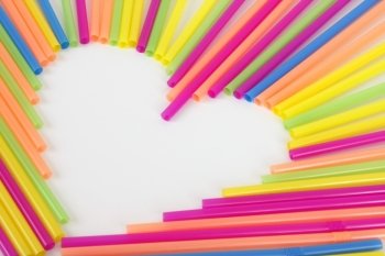 A heart made from colorful straws on a white background.