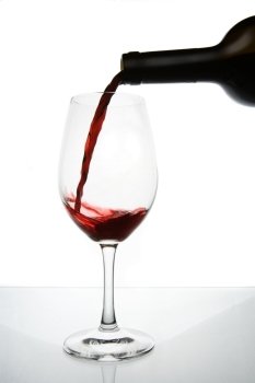 Pouring red wine to a wineglass