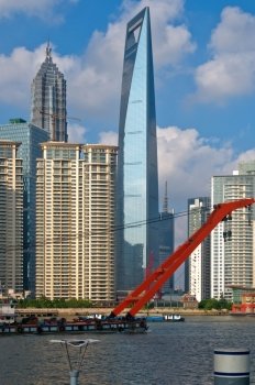 shanghai pudong view from puxi ,with big red crane boat crossing  huangpu river