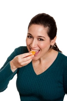 Beautiful happy woman eating a slice of mandarin orange fruit full of vitamin C for a healthy diet, isolated.
