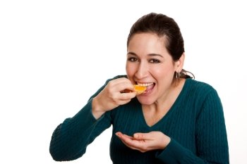 Beautiful happy woman eating a slice of juicy mandarin orange fruit full of vitamin C for a healthy diet, isolated.