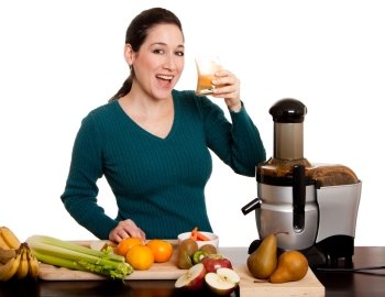 Beautiful woman drinking and enjoying a freshly squeezed organic fruit juice made with her juicer in kitchen, isolated.