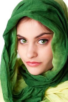 Portrait of mysterious beautiful Caucasian Hispanic Latina woman face with green penetrating eyes and green fashion scarf wrapped around head, isolated.