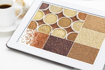 Reviewing pictures of healthy gluten free grains (quinoa, kaniwa, brown rice, millet, amaranth, teff, buckwheat, sorghum) on a digital tablet with a cup of coffee. All screen pictures copyright by the photographer.
