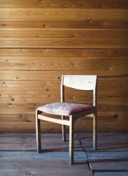 Vintage old wooden chair in grungy interior.
