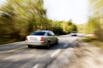 A motion blur image of a speeding car