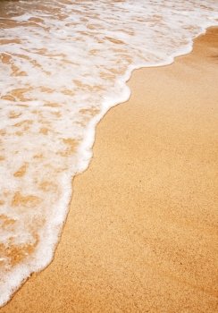 A wave breaking on the sand - Background texture