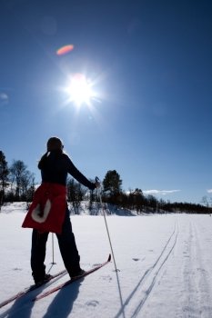 A woman in a winter landscape cross country skiing