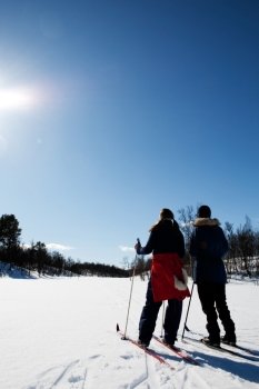 Two women in a winter landscape cross country skiing