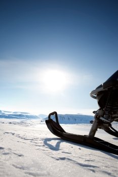 Snowmobile against a deep blue sky