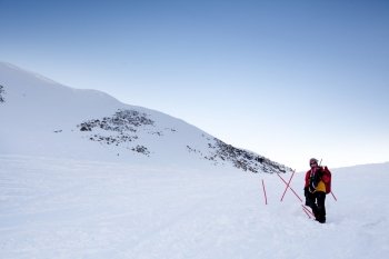 A female mountaineer on a snow filled slope, Svalbard, Norway