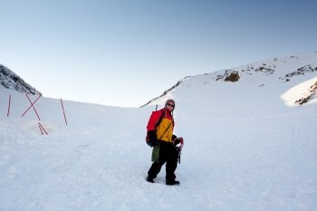 A female mountaineer on a snow filled slope, Svalbard, Norway