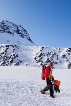A female mountaineer against a winter mountain landscape