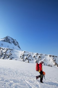 A female mountaineer against a mountain landscape, Svalbard, Norway