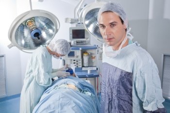 Confident male doctor in operating room