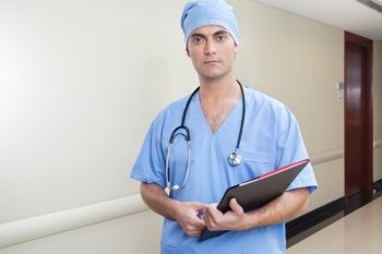 Surgeon with database in hospital hallway