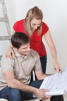 Couple looking at home blueprints together