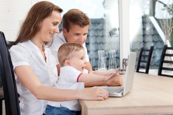 Young family chatting through computer