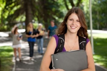 Portrait of a relaxed pretty college girl with binder