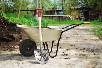 wheel barrow on the land at the county with land and shovel