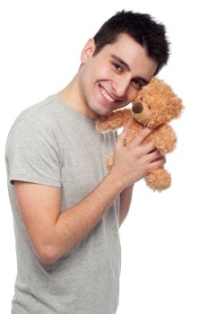 lovely portrait of a young man cuddling a teddy bear (isolated on white background)