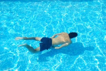 vibrant photo of a young adult swimming underwater