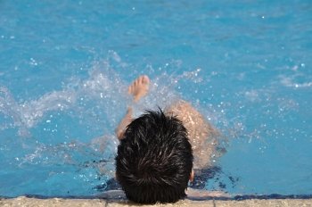 smiling young man doing water gymnastics (back view)
