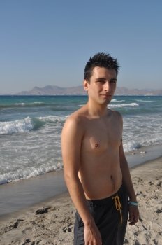 handsome young man relaxing at Kos beach in Greece (blue sky)