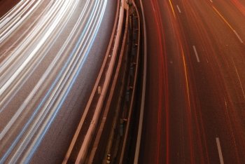 a night time shot of speeding traffic on a freeway
